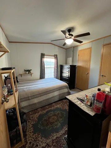 a bedroom with a bed and a chandelier