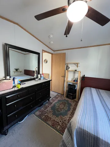 a bed room with a bed and a television