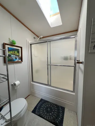 a bathroom with a toilet and a shower