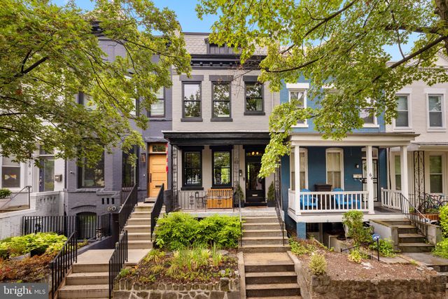 a front view of a house with garden and porch