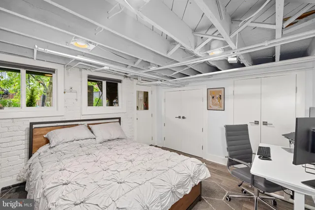 a bedroom with a bed and a flat tv screen