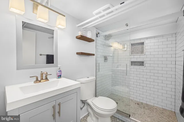 a bathroom with a sink toilet and shower