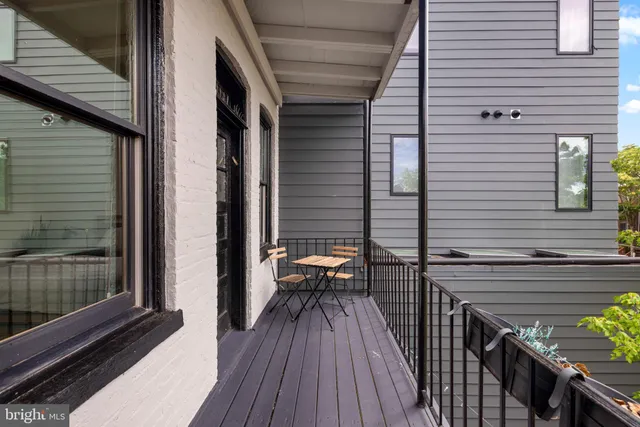 a view of a balcony with chairs
