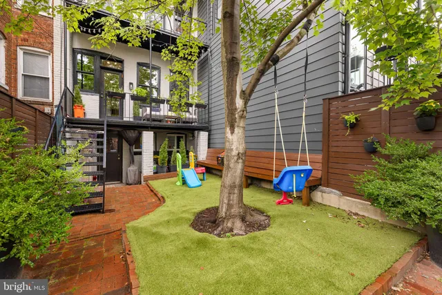 a front view of a house with swimming pool and glass windows