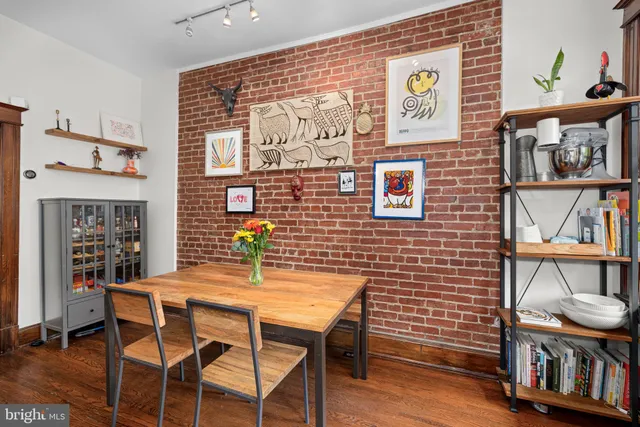 a view of a dining room with furniture and a potted plant