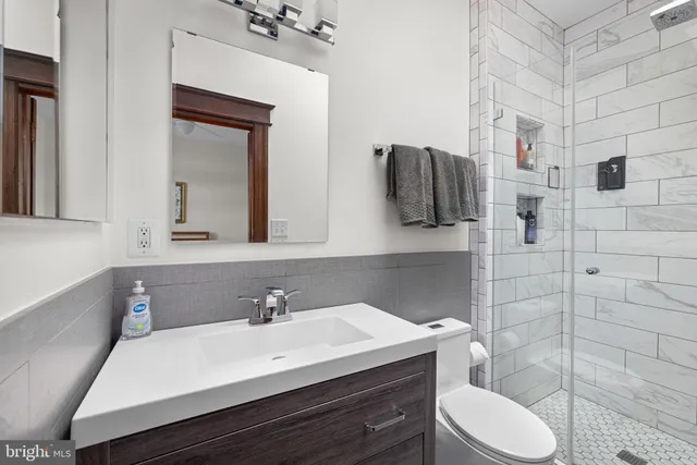 a bathroom with a sink vanity and toilet