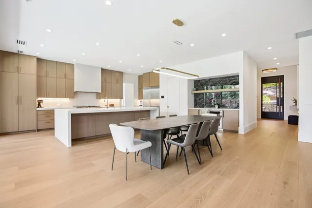 a large kitchen with a table and chairs