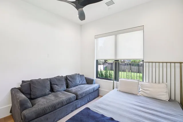 a living room with furniture and a floor to ceiling window