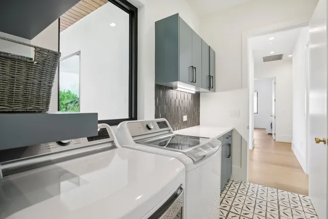 a room with sink washer and dryer