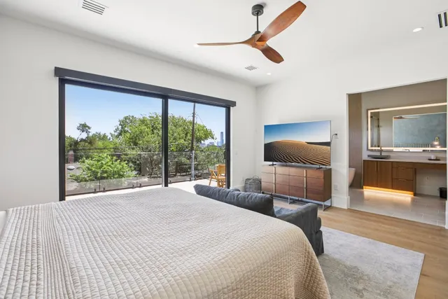 a bedroom with a large bed and a large window