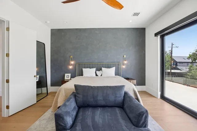 a bedroom with a bed and large mirror