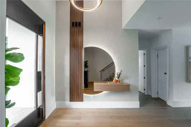 a view of a living room with a fireplace and wooden floor