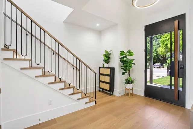 a view of staircase with railing and a potted plant