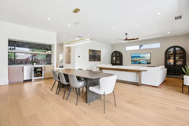 a living room with furniture a rug and kitchen view