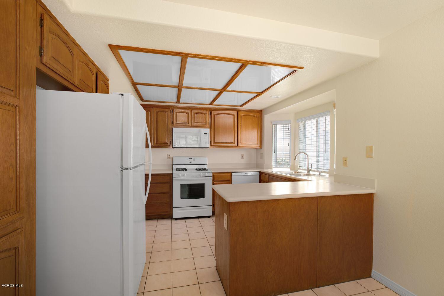 2188 Eastridge Loop Oxnard, CA 93036 - Photo 12 of 27 a kitchen with stainless steel appliances a sink stove and cabinets