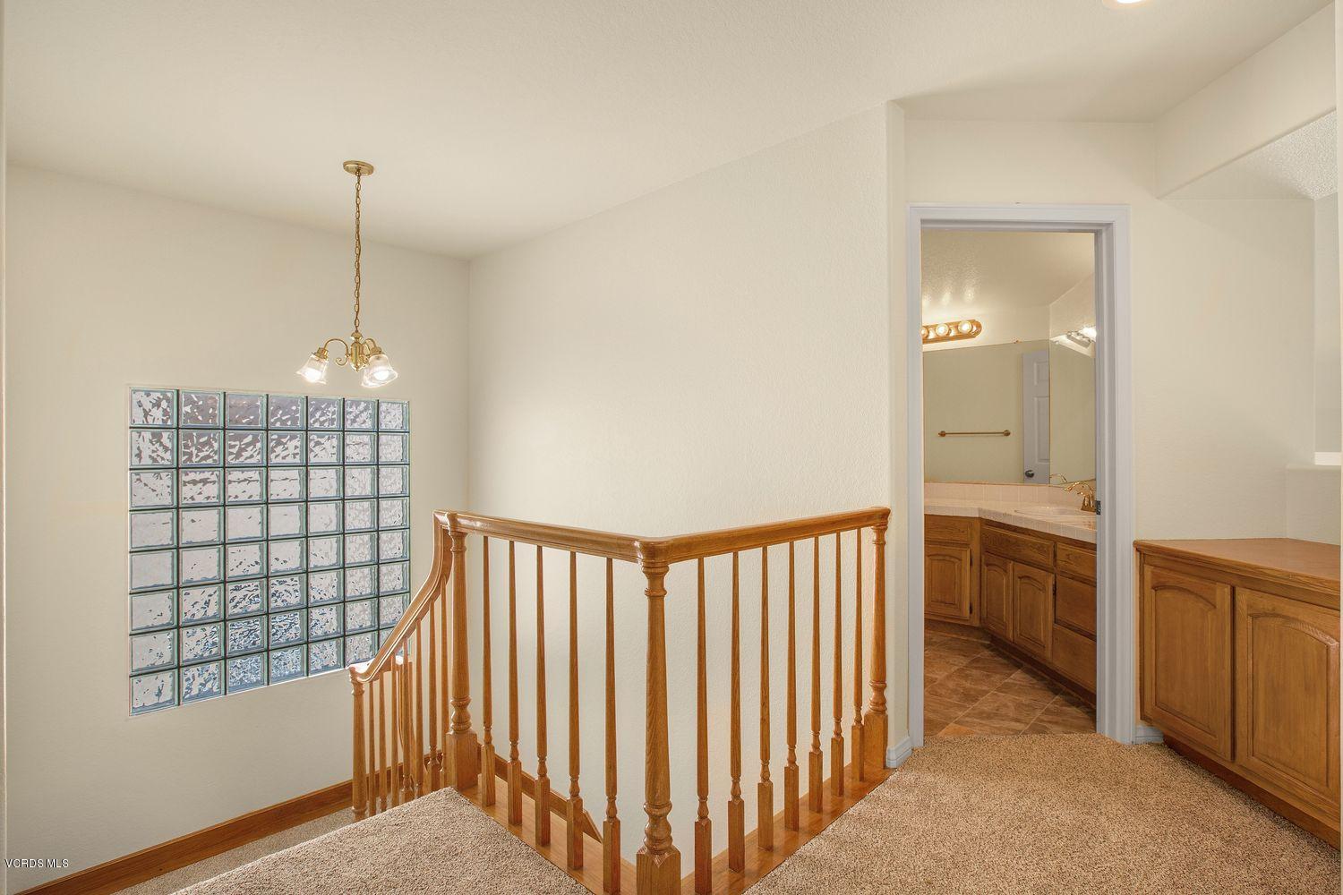 2188 Eastridge Loop Oxnard, CA 93036 - Photo 13 of 27 a view of a hallway with closet and chandelier