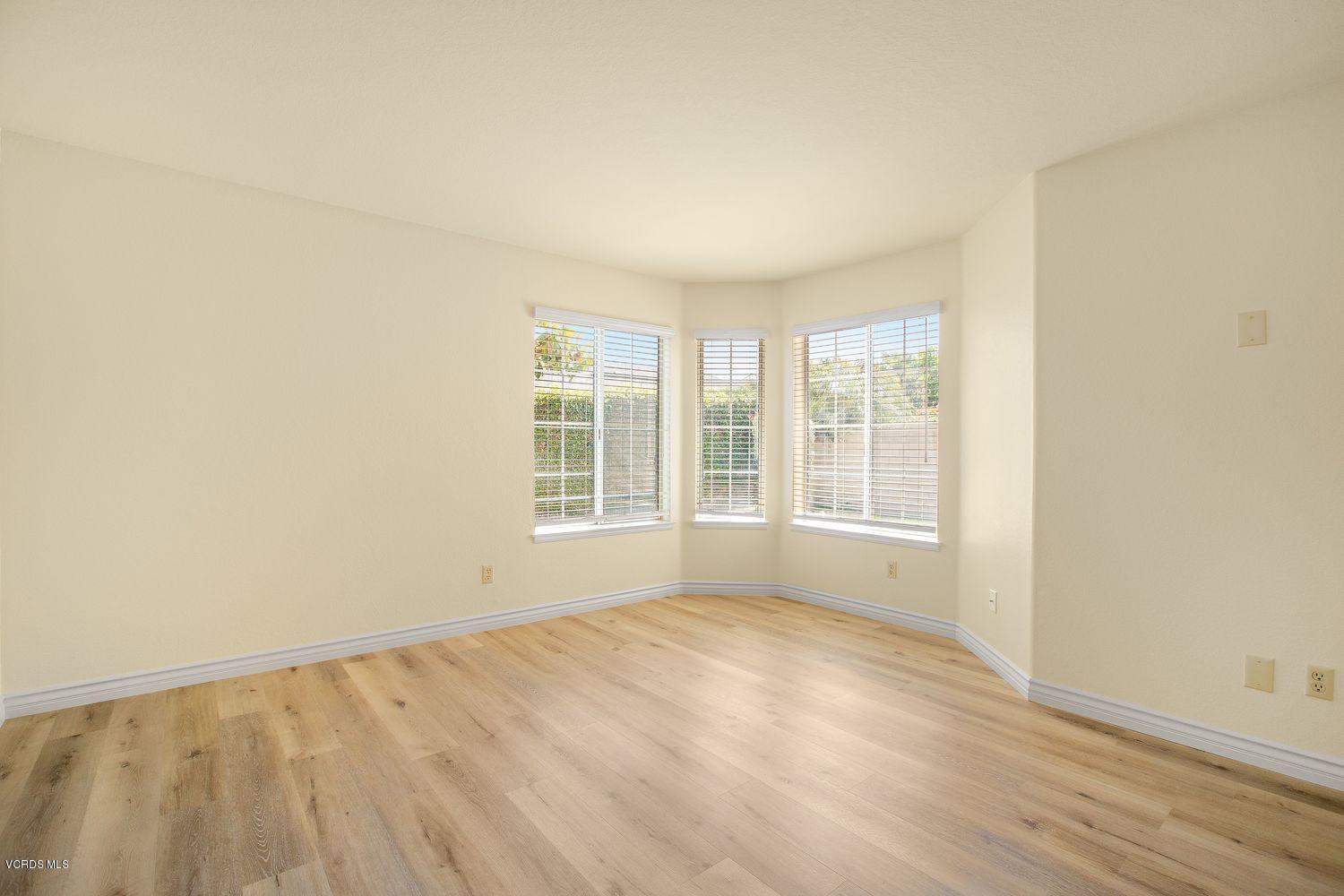 2188 Eastridge Loop Oxnard, CA 93036 - Photo 14 of 27 an empty room with wooden floor and windows