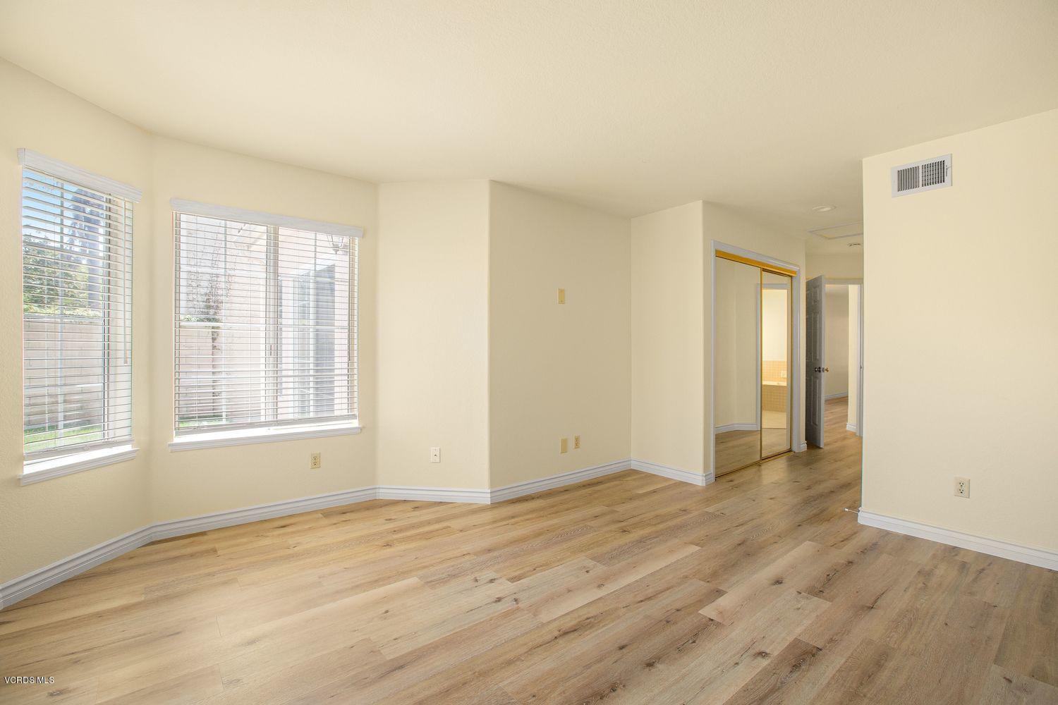 2188 Eastridge Loop Oxnard, CA 93036 - Photo 15 of 27 a view of an empty room with wooden floor and a window