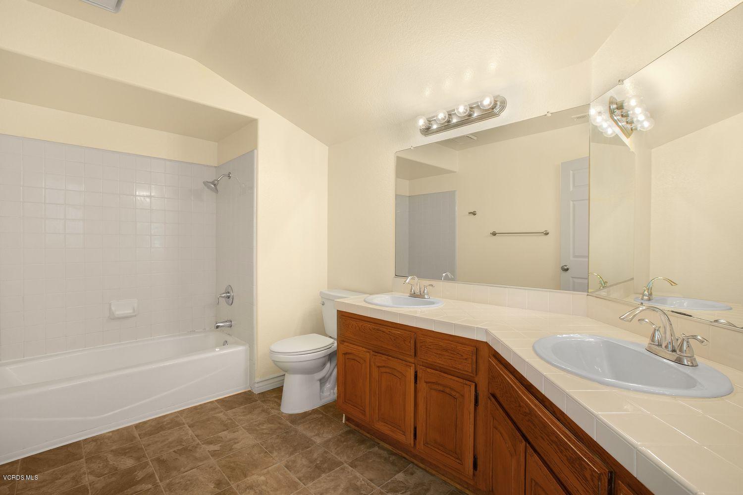 2188 Eastridge Loop Oxnard, CA 93036 - Photo 20 of 27 a bathroom with a double vanity sink mirror double and bathtub