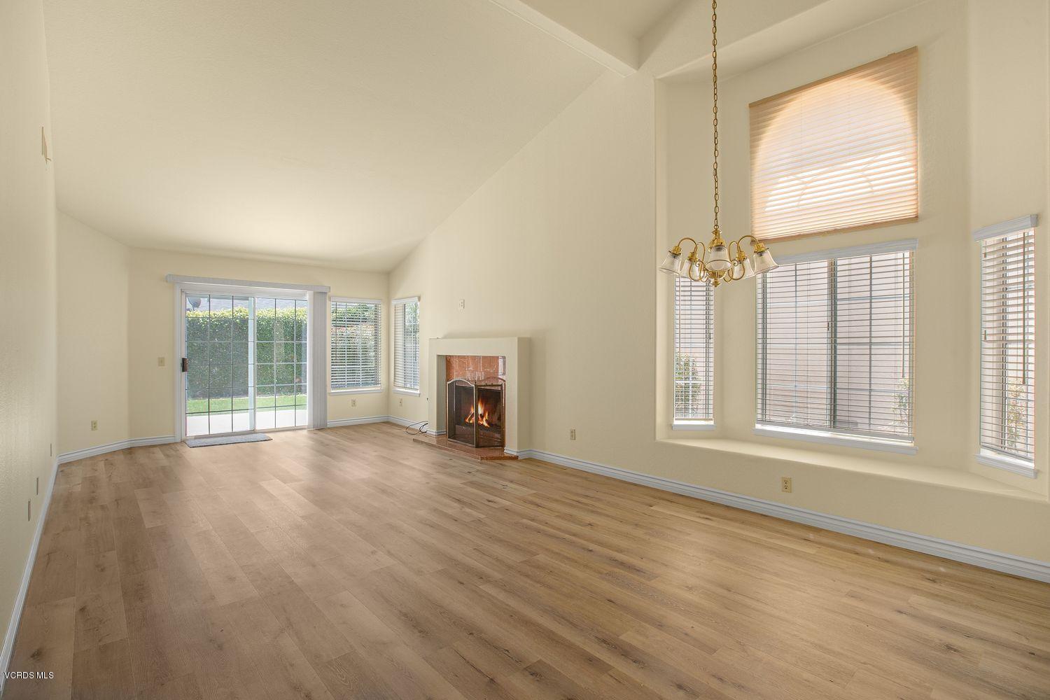 2188 Eastridge Loop Oxnard, CA 93036 - Photo 4 of 27 an empty room with wooden floor fan and windows