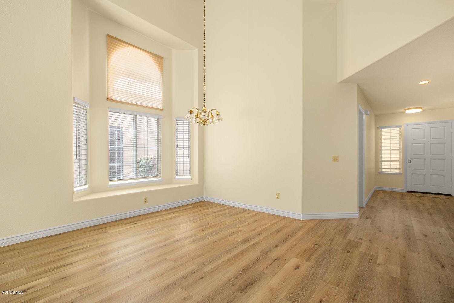 2188 Eastridge Loop Oxnard, CA 93036 - Photo 8 of 27 an empty room with wooden floor and windows
