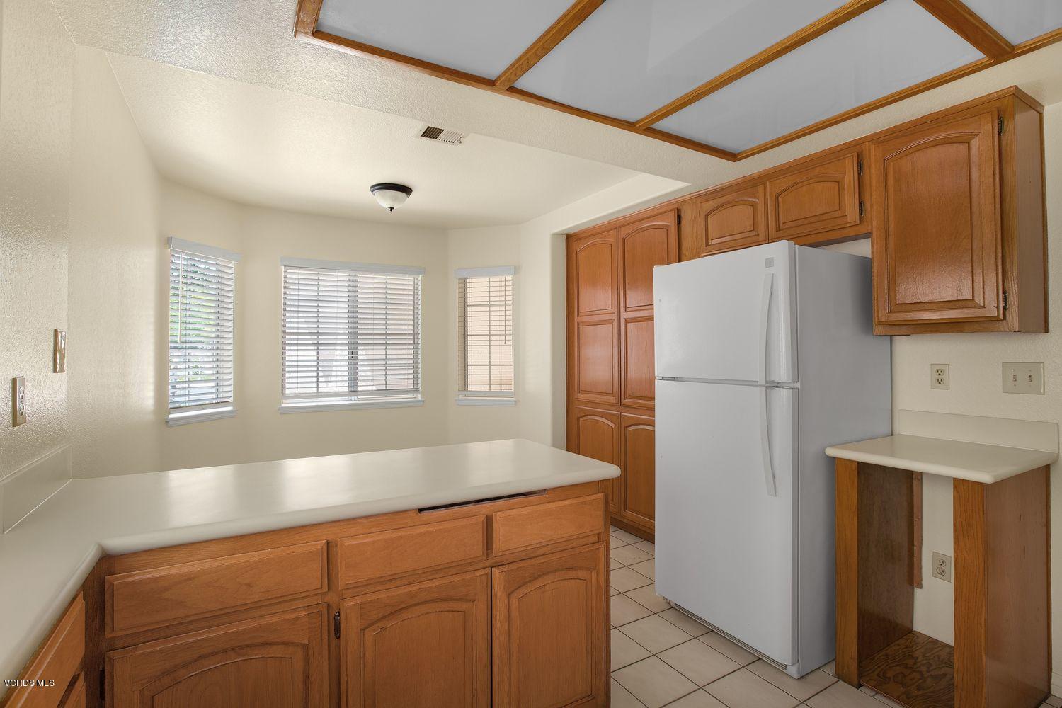 2188 Eastridge Loop Oxnard, CA 93036 - Photo 10 of 27 a kitchen with a refrigerator and a sink