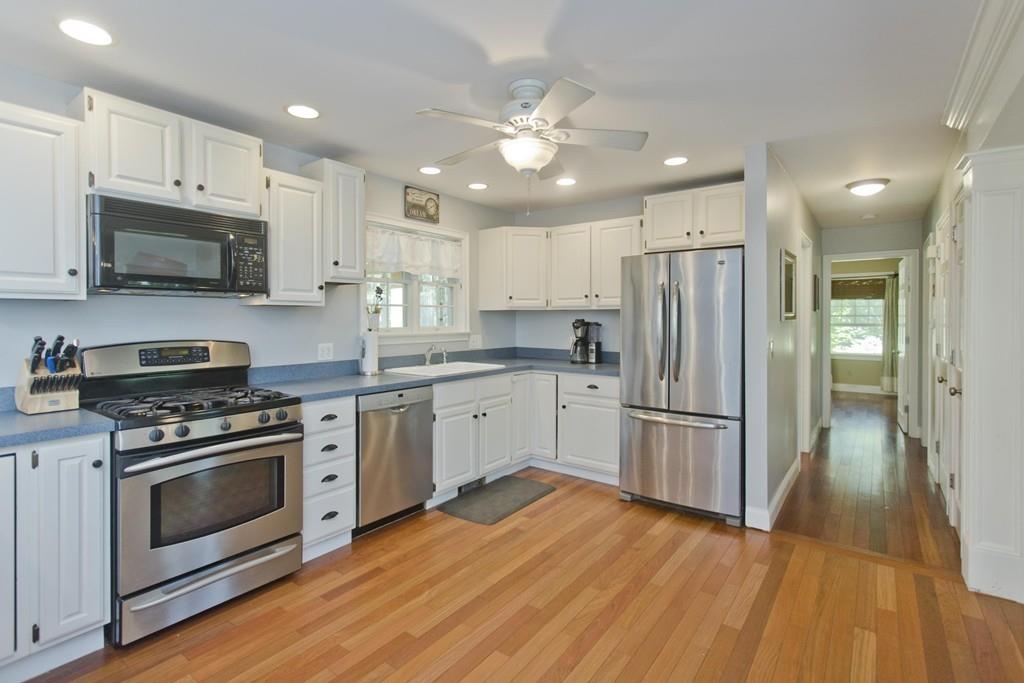 201 Plumtree Road Sunderland, MA 01375 - Photo 11 of 38 a kitchen with stainless steel appliances granite countertop a refrigerator stove a sink and white cabinets