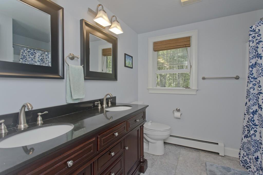 201 Plumtree Road Sunderland, MA 01375 - Photo 31 of 38 a bathroom with a double vanity sink toilet and a mirror