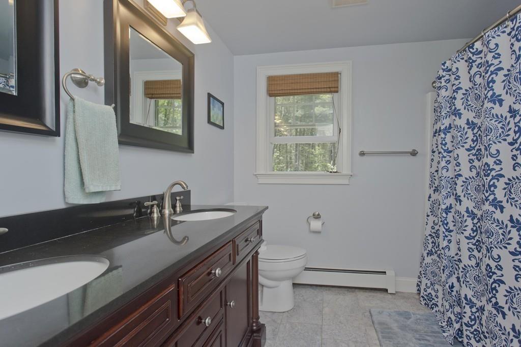 201 Plumtree Road Sunderland, MA 01375 - Photo 32 of 38 a bathroom with a granite countertop sink a mirror and a shower