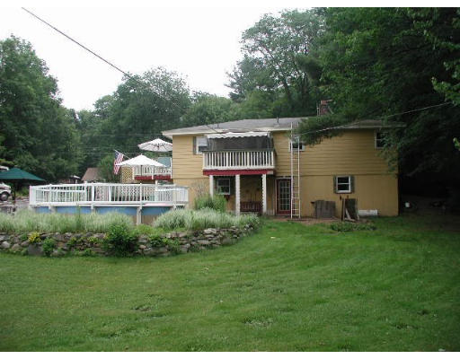 74 Longley Road Shirley, MA 01464 - Photo 2 of 4 a front view of a house with a garden