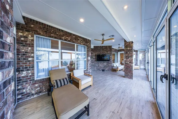 a living room with furniture a fireplace and a floor to ceiling window