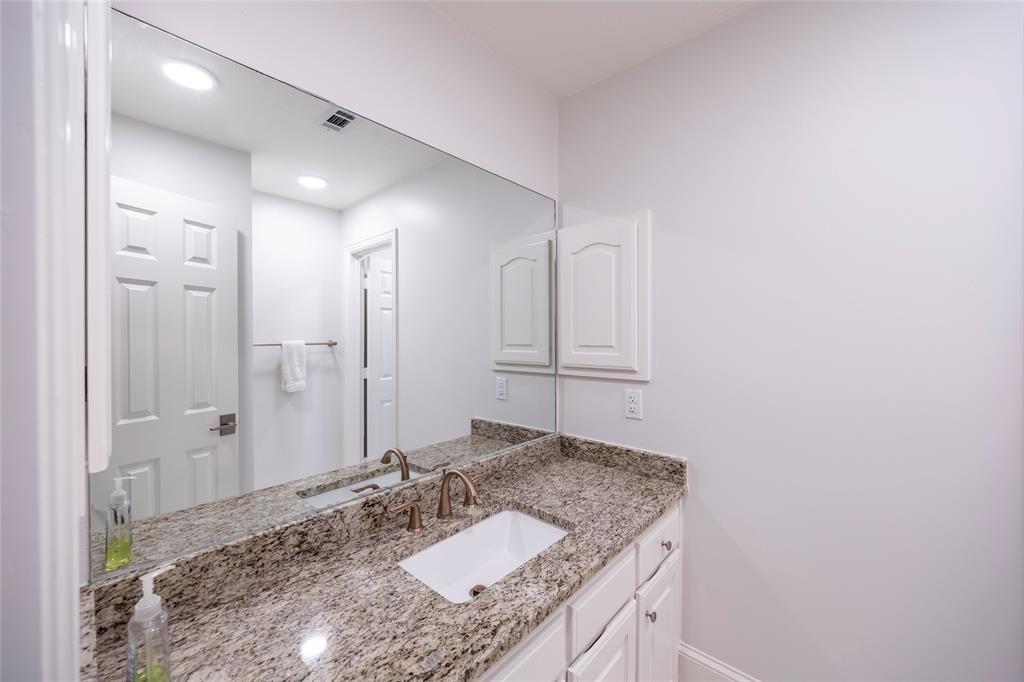1190 Emerald Sound Boulevard Oak Point, TX 75068 - Photo 28 of 37 a bathroom with a granite countertop sink and a mirror