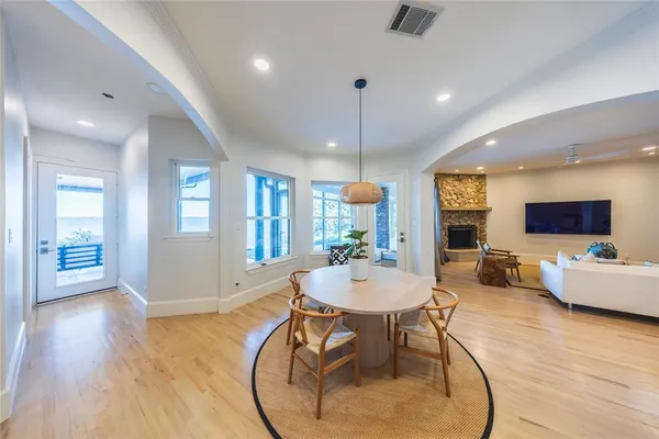 a living room with furniture a wooden floor and a chandelier