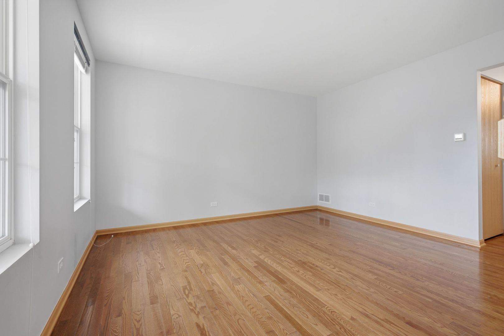 1758 Edith Lane Aurora, IL 60504 - Photo 8 of 28 a view of an empty room and wooden floor
