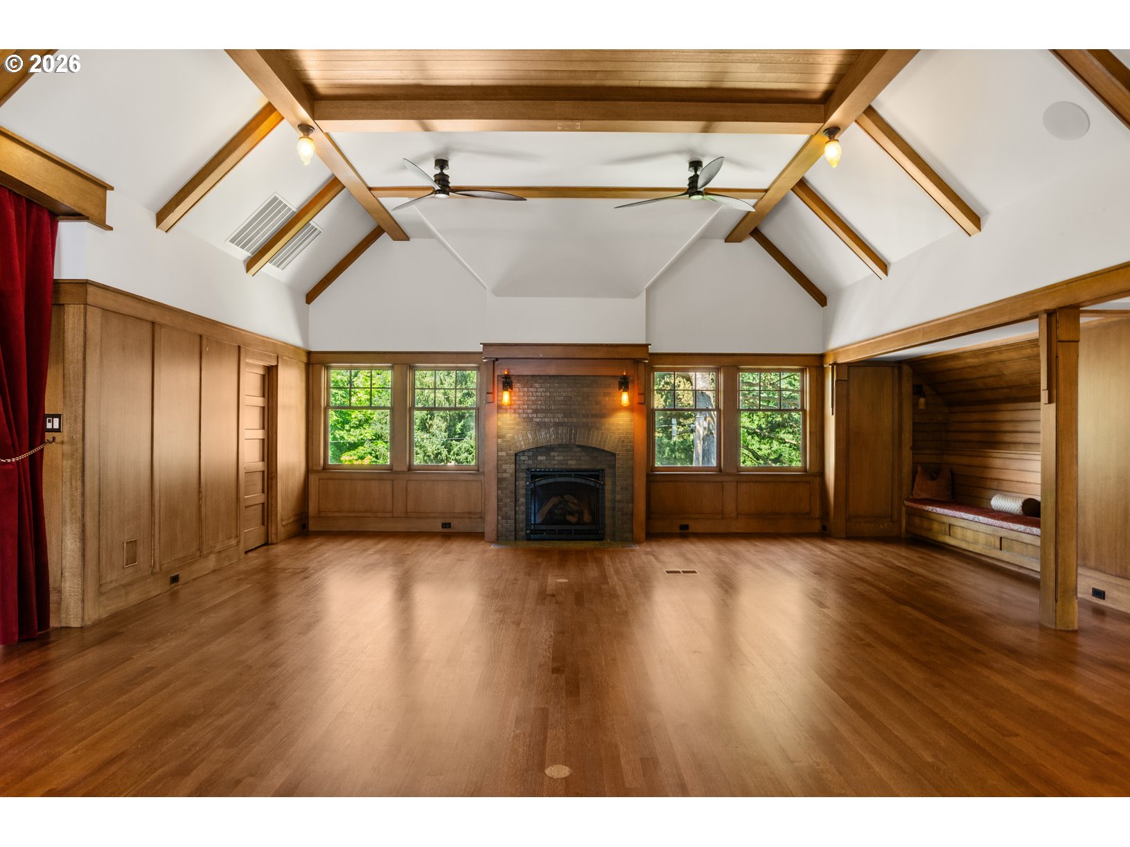 2023 Southwest Montgomery Drive Portland, OR 97201 - Photo 25 of 46 a view of an empty room with wooden floor fireplace and a window