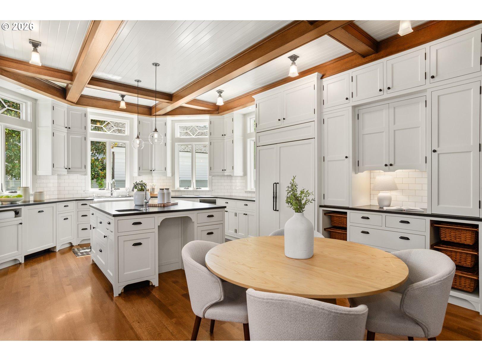 2023 Southwest Montgomery Drive Portland, OR 97201 - Photo 9 of 46 a kitchen with stainless steel appliances kitchen island granite countertop a table chairs and white cabinets