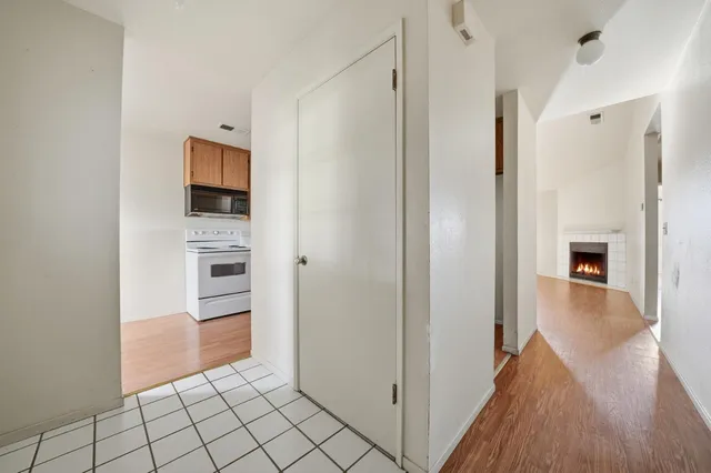a kitchen with wooden floors and white appliances