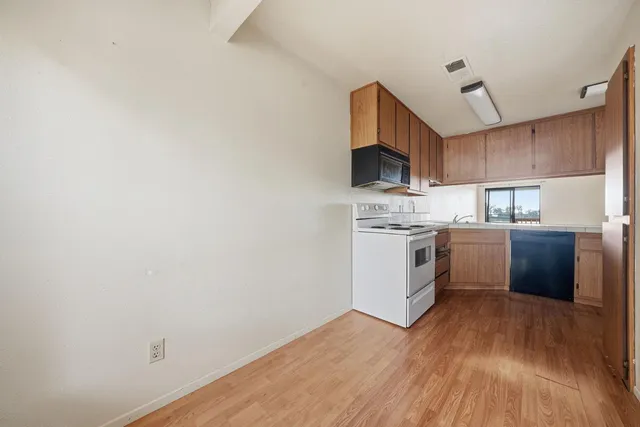 a kitchen with a sink and a refrigerator