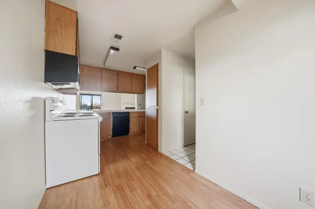 a kitchen with a white stove top oven and refrigerator