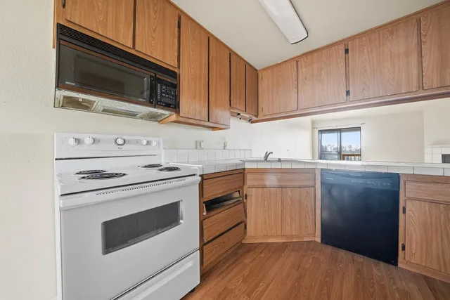 a view of a kitchen with a sink and dishwasher