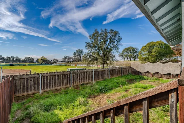 a view of a garden with wooden fence