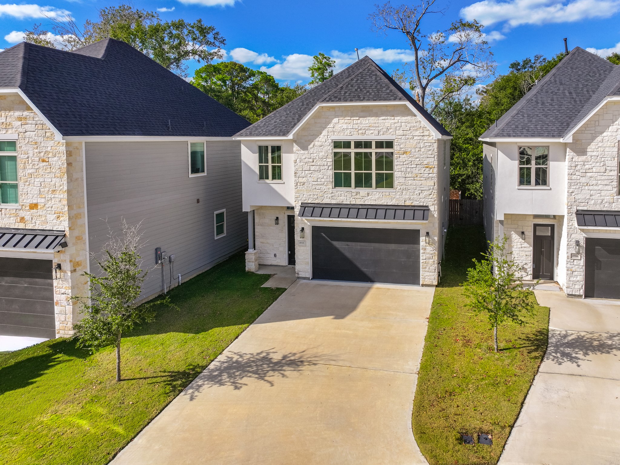 a front view of a house with a garden and plants