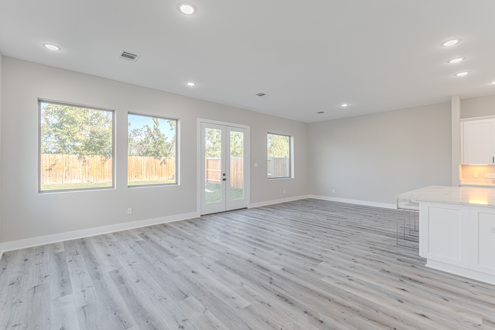 4910 Wunder Way Houston, TX 77069 - Photo 15 of 49 an empty room with wooden floor and windows