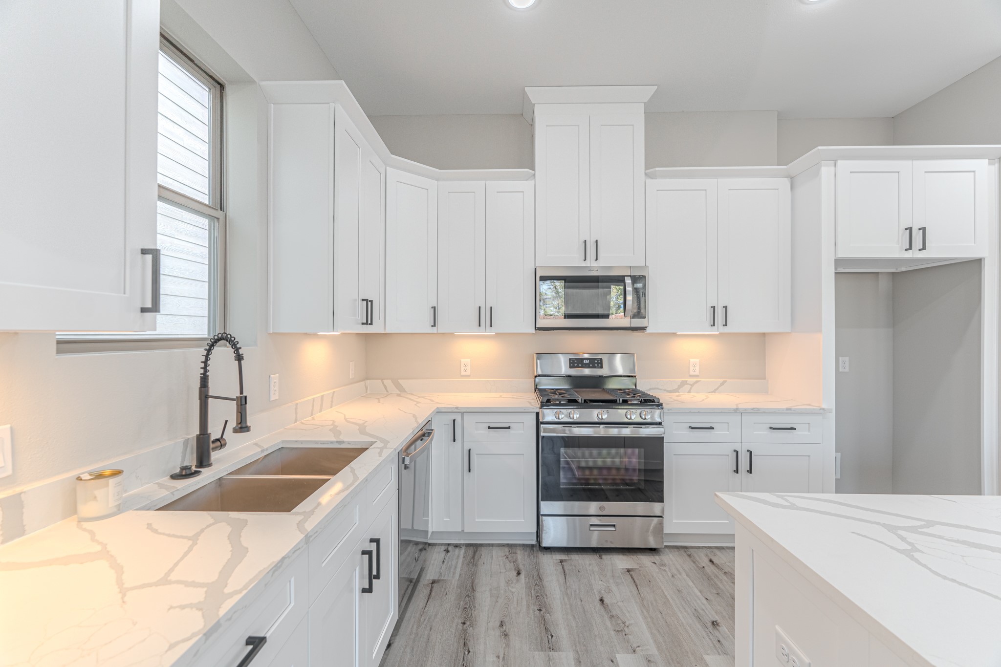 4910 Wunder Way Houston, TX 77069 - Photo 23 of 49 a kitchen with granite countertop a sink stove and cabinets