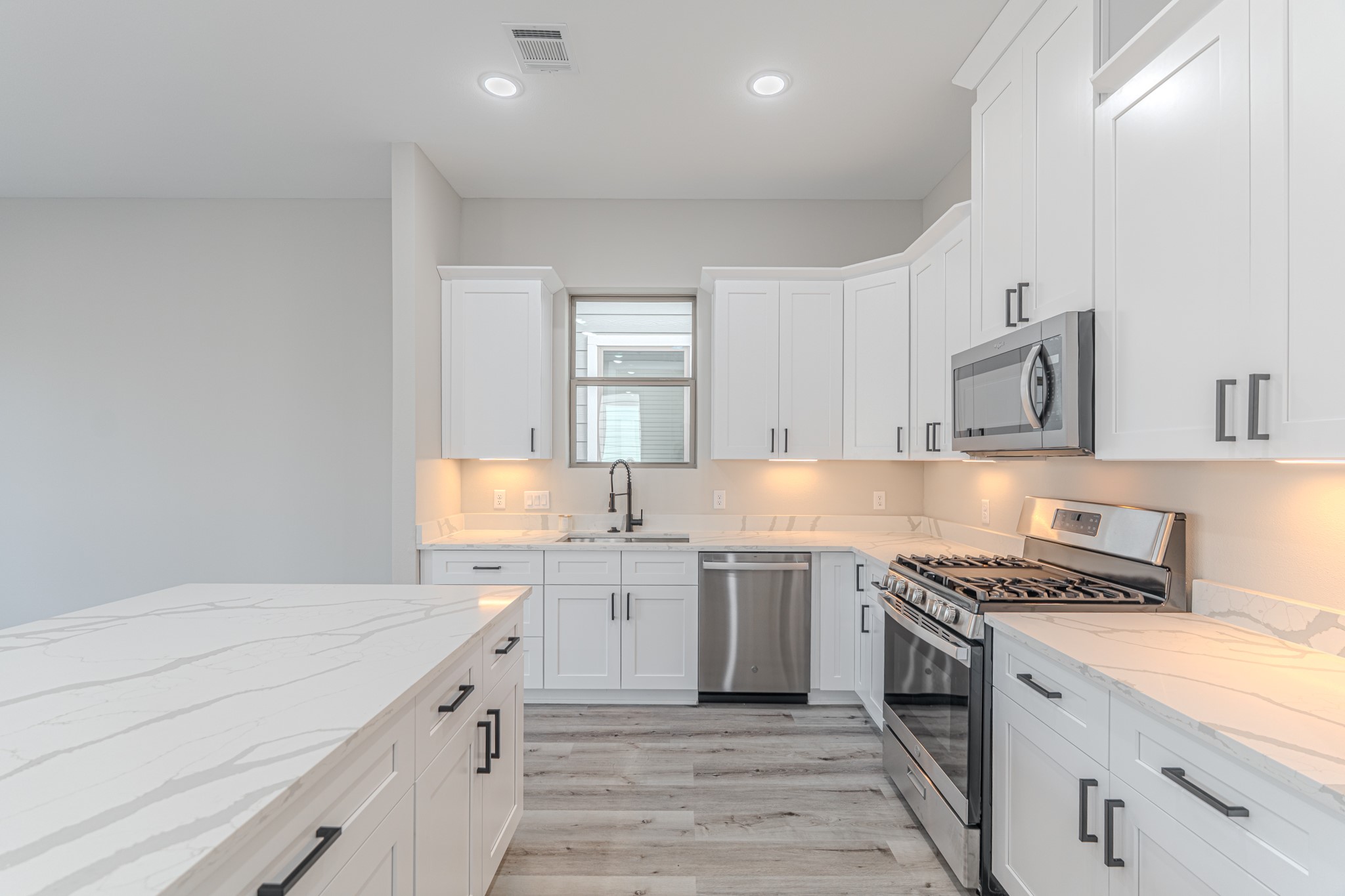 4910 Wunder Way Houston, TX 77069 - Photo 25 of 49 a kitchen with a sink stove top oven and cabinets