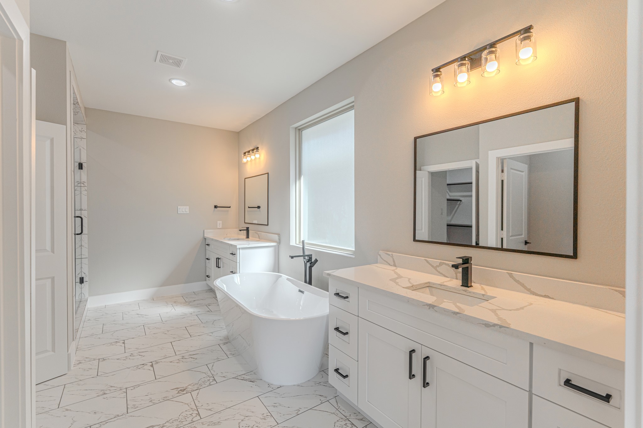 4910 Wunder Way Houston, TX 77069 - Photo 36 of 49 a bathroom with a double vanity sink mirror and bathtub