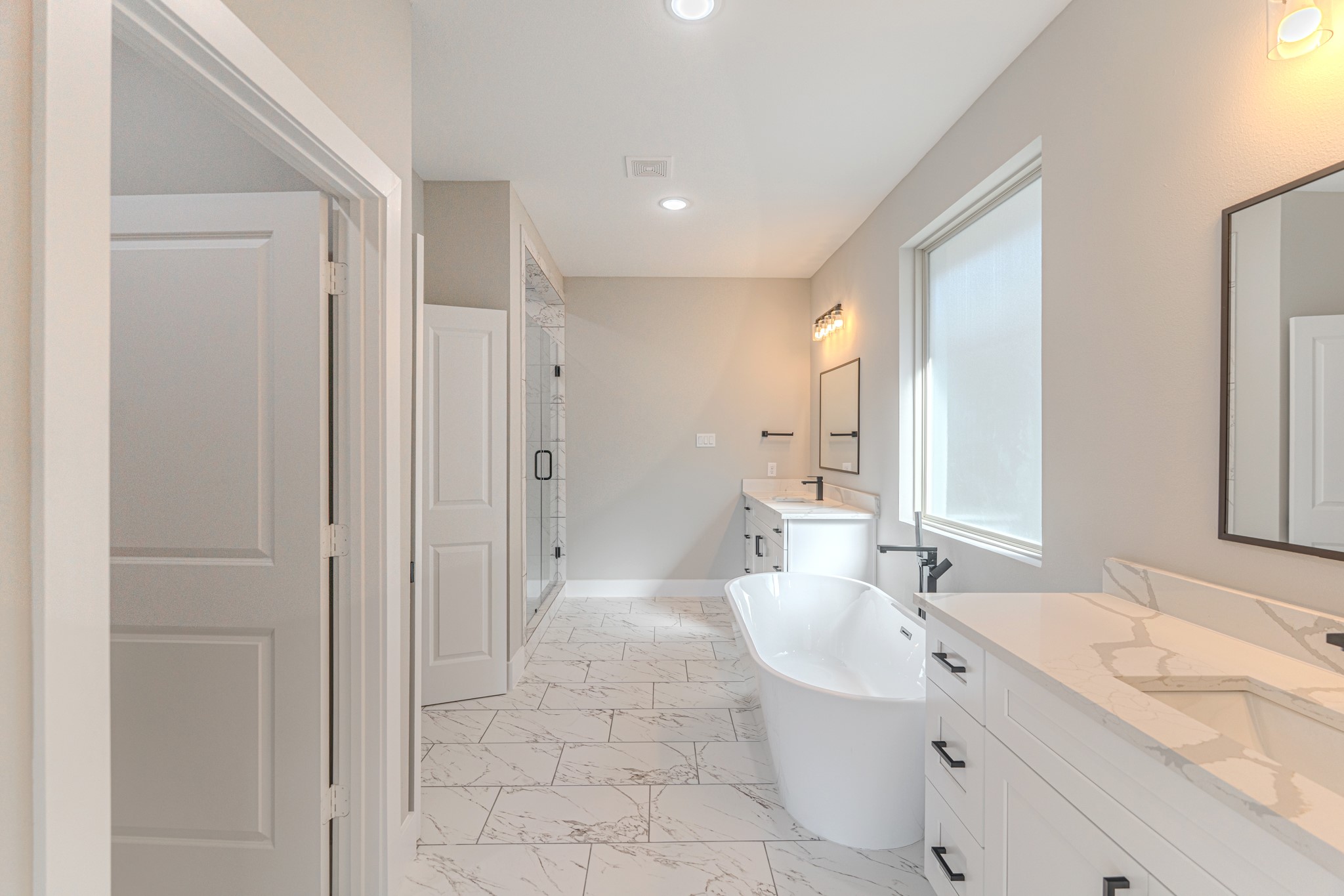 4910 Wunder Way Houston, TX 77069 - Photo 37 of 49 a spacious bathroom with a double vanity sink mirror and shower