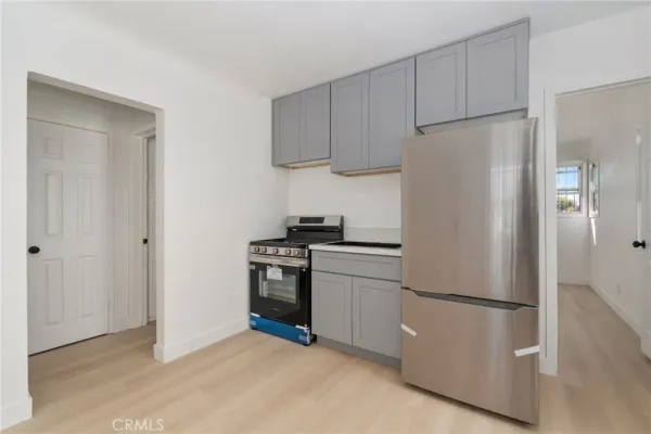 a kitchen with stainless steel appliances a refrigerator sink and cabinets