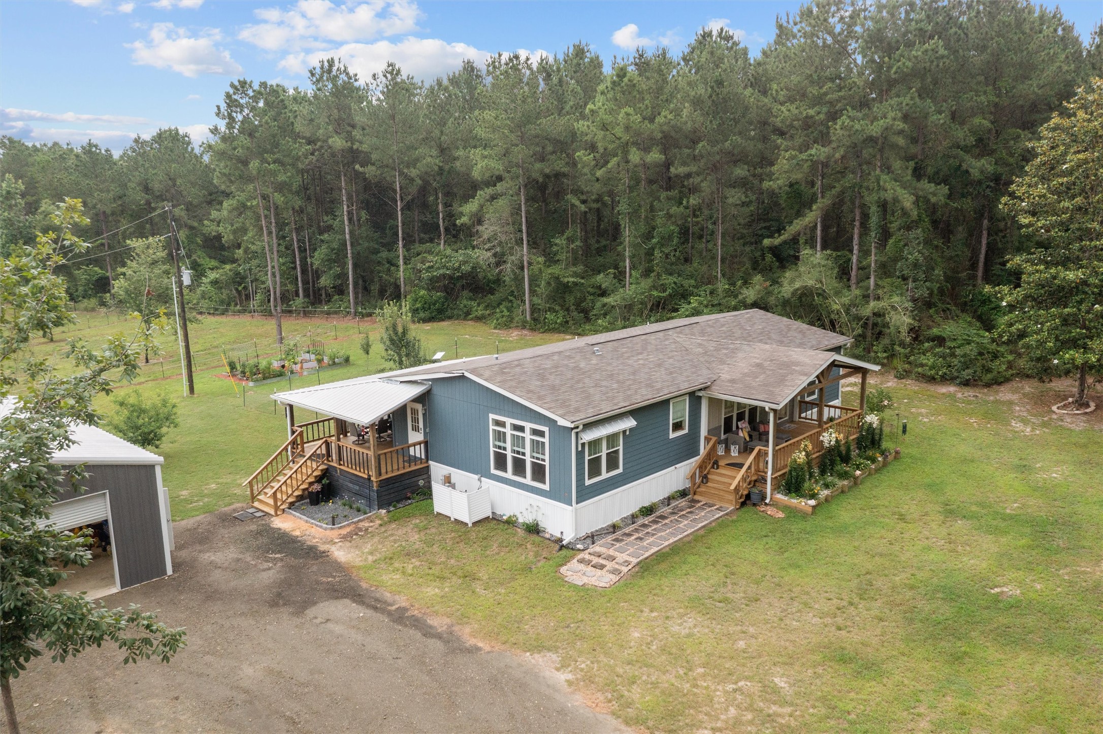 275 County Road 3215 Colmesneil, TX 75938 - Photo 14 of 34 a view of a house with pool and a yard