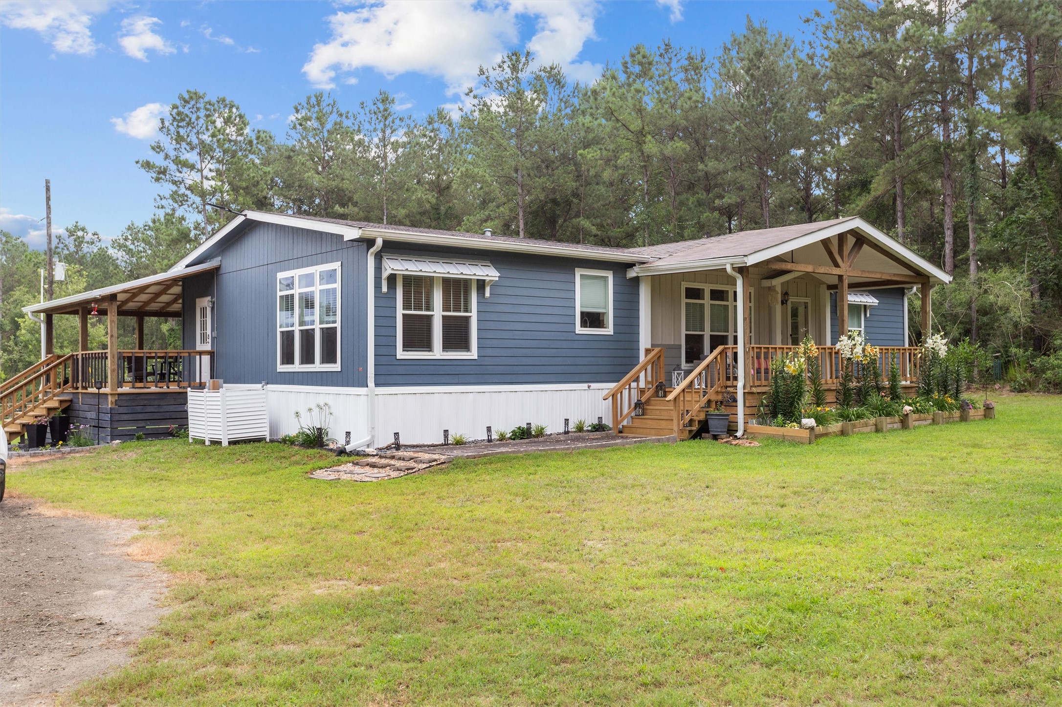 275 County Road 3215 Colmesneil, TX 75938 - Photo 2 of 34 a view of a house with a yard and sitting area